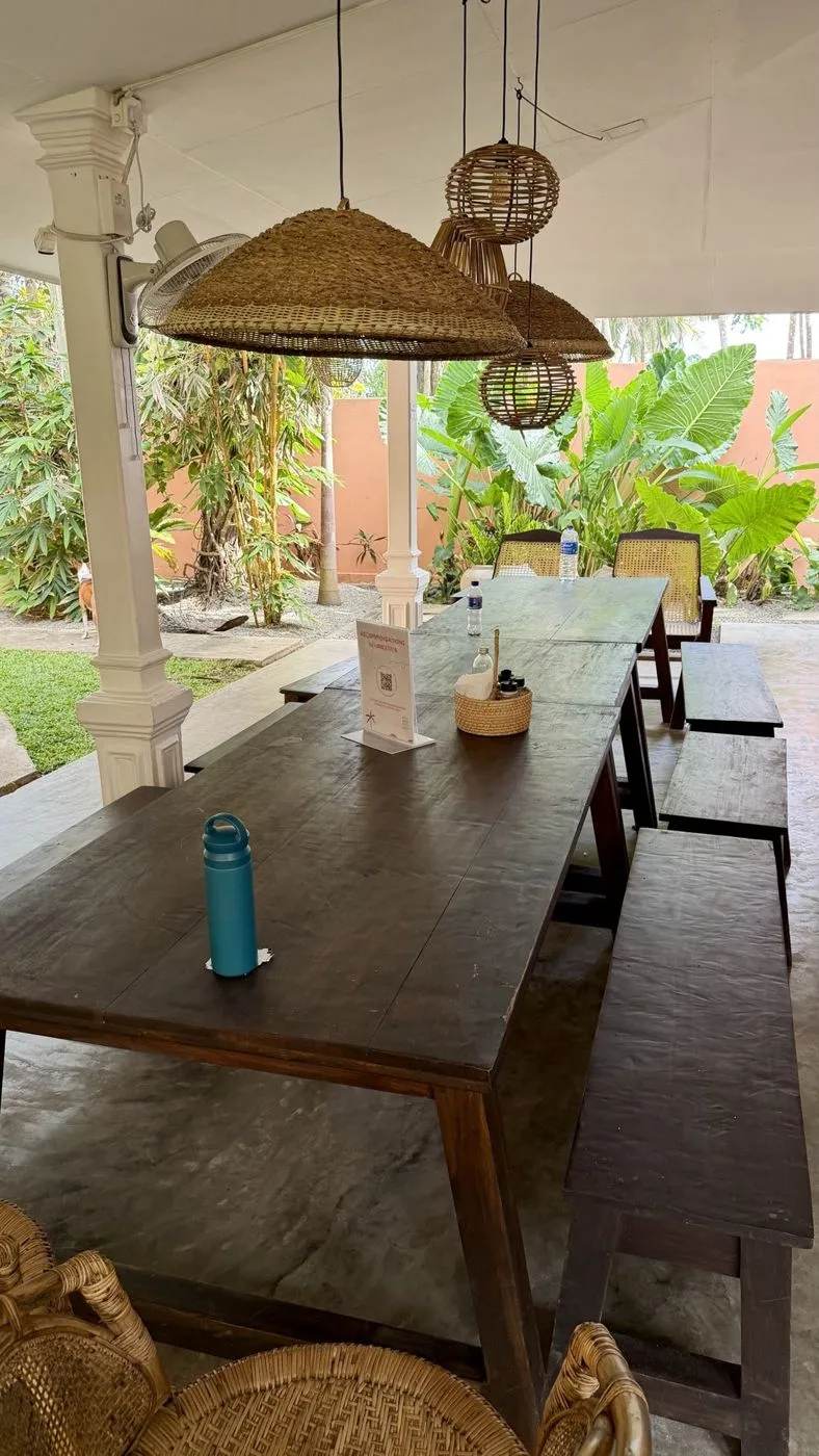 The long communal table on the veranda, garden behind