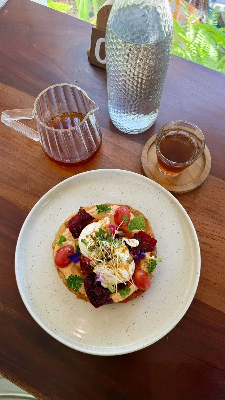 Breakfast: poached egg on toast with beetroot, tomatoes and edible flowers, with pour-over coffee