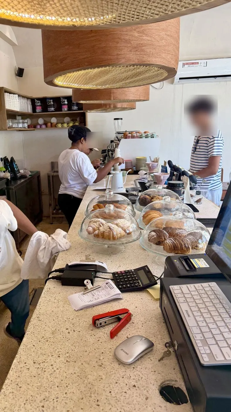 Pastry counter with croissants under glass domes