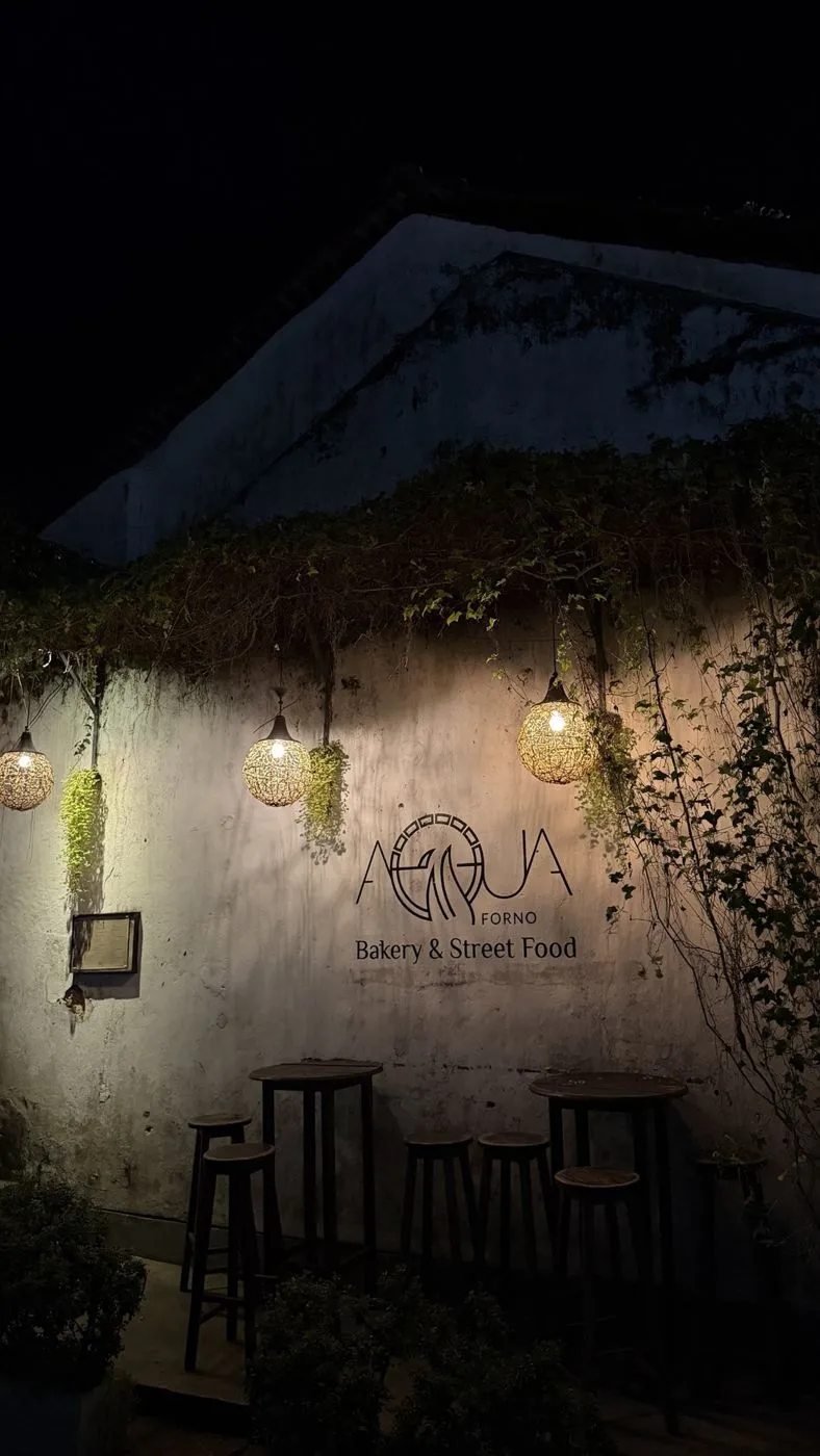 Aqua Forno bakery and street food, with lanterns and creepers on an old wall