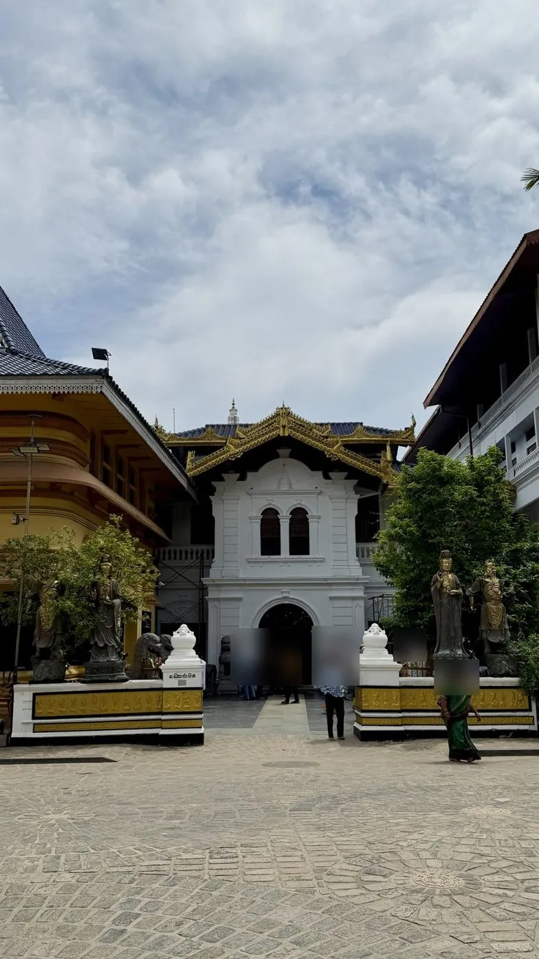 Gangaramaya's courtyard and gateway, lined with bronze guardian statues