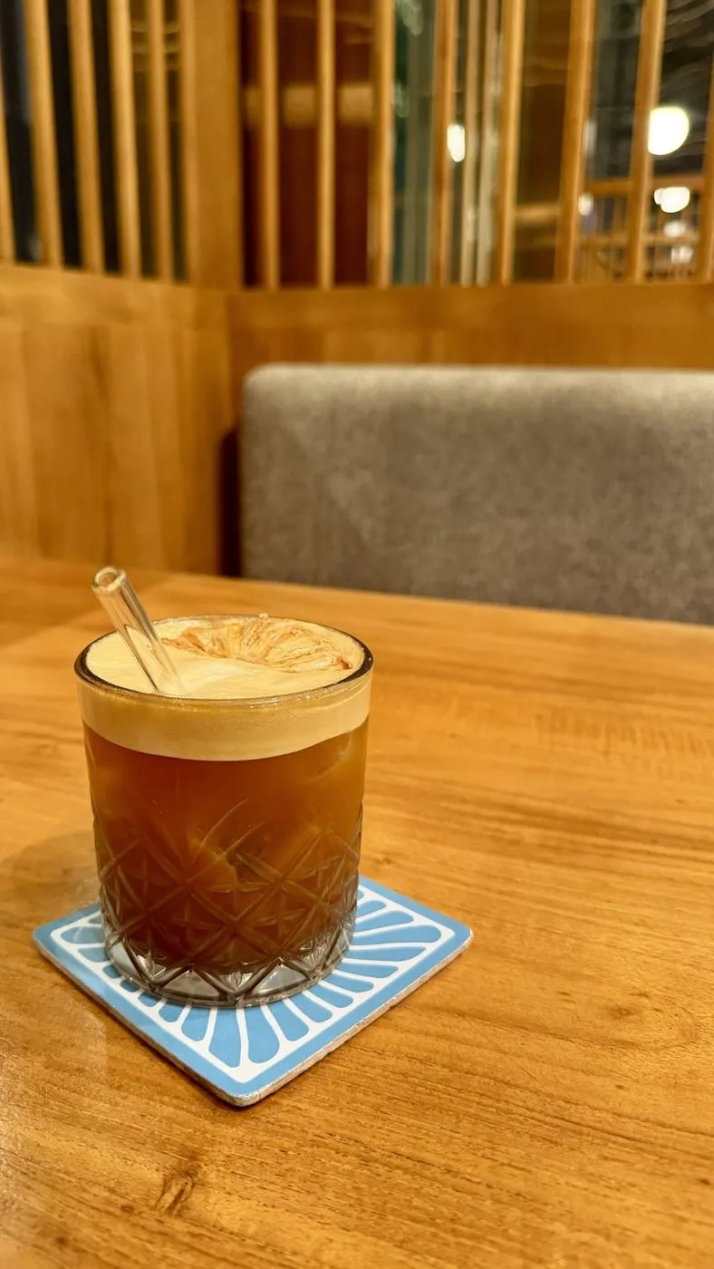 Iced coffee with dried orange at Grind