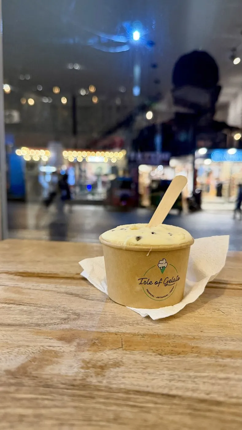 Passion fruit gelato with Ella's Main Street lit up behind
