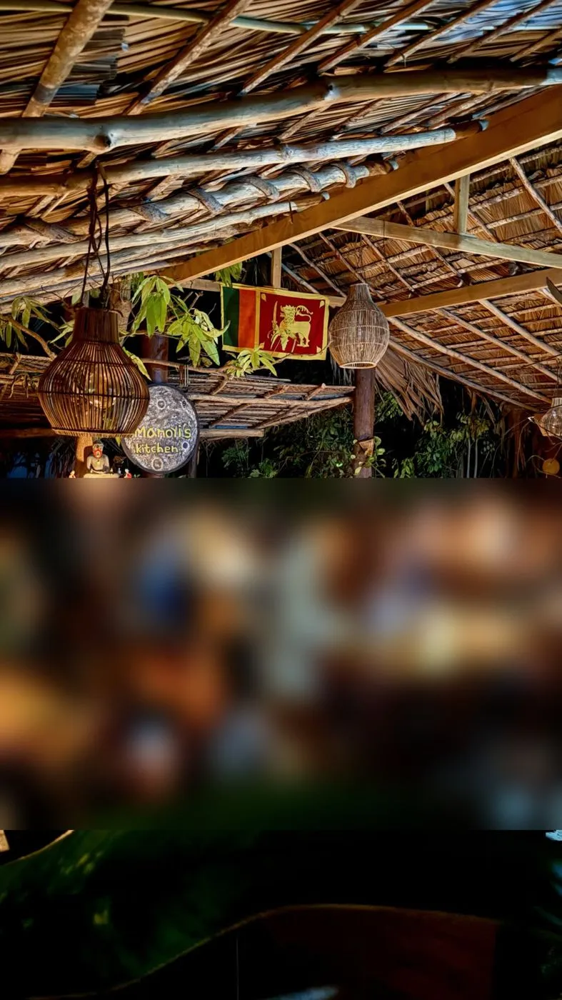 Candlelit dining under the thatch, Sri Lankan flag overhead