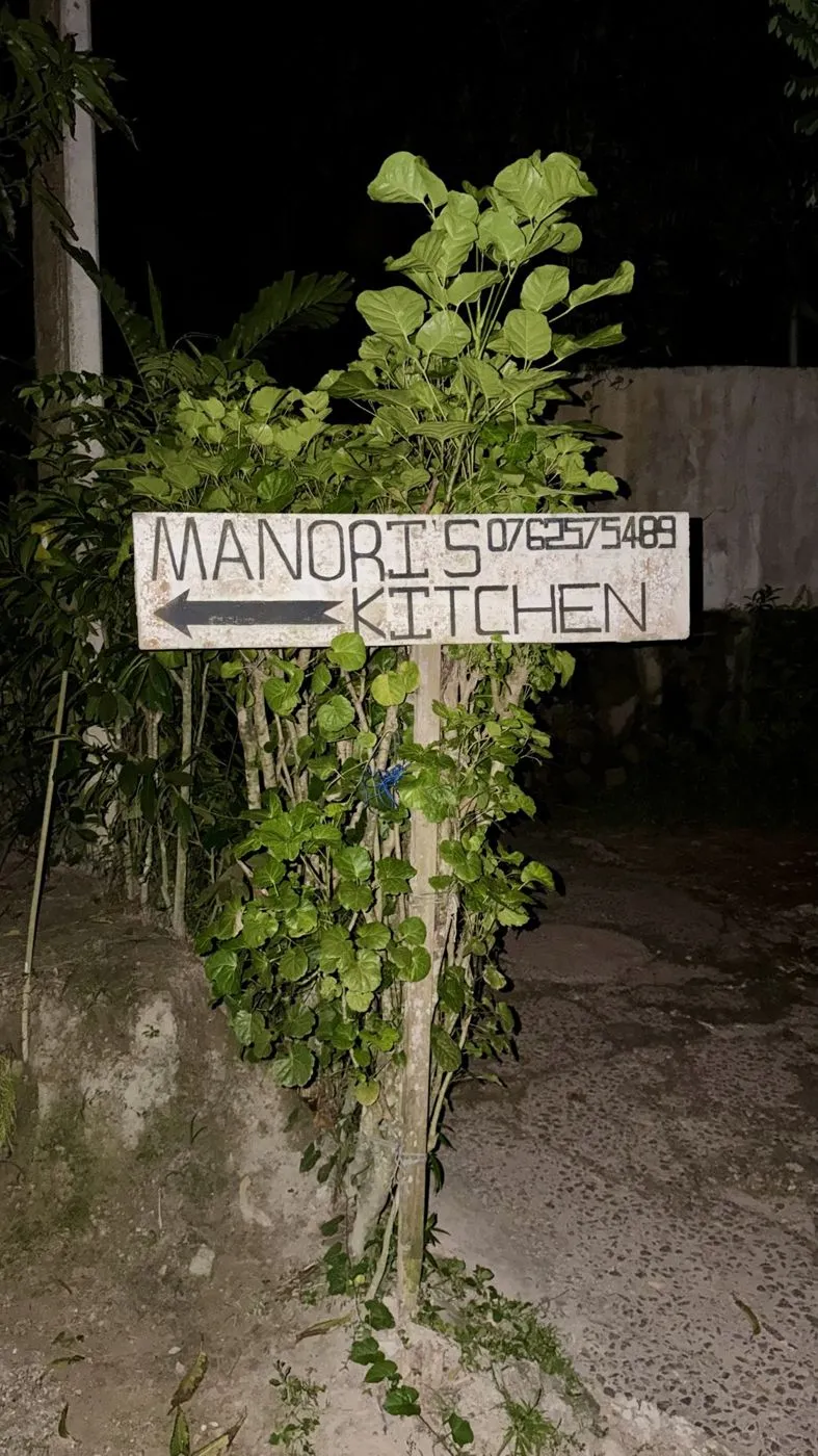 The hand-painted roadside sign pointing the way (Manori's: 076 257 5489)