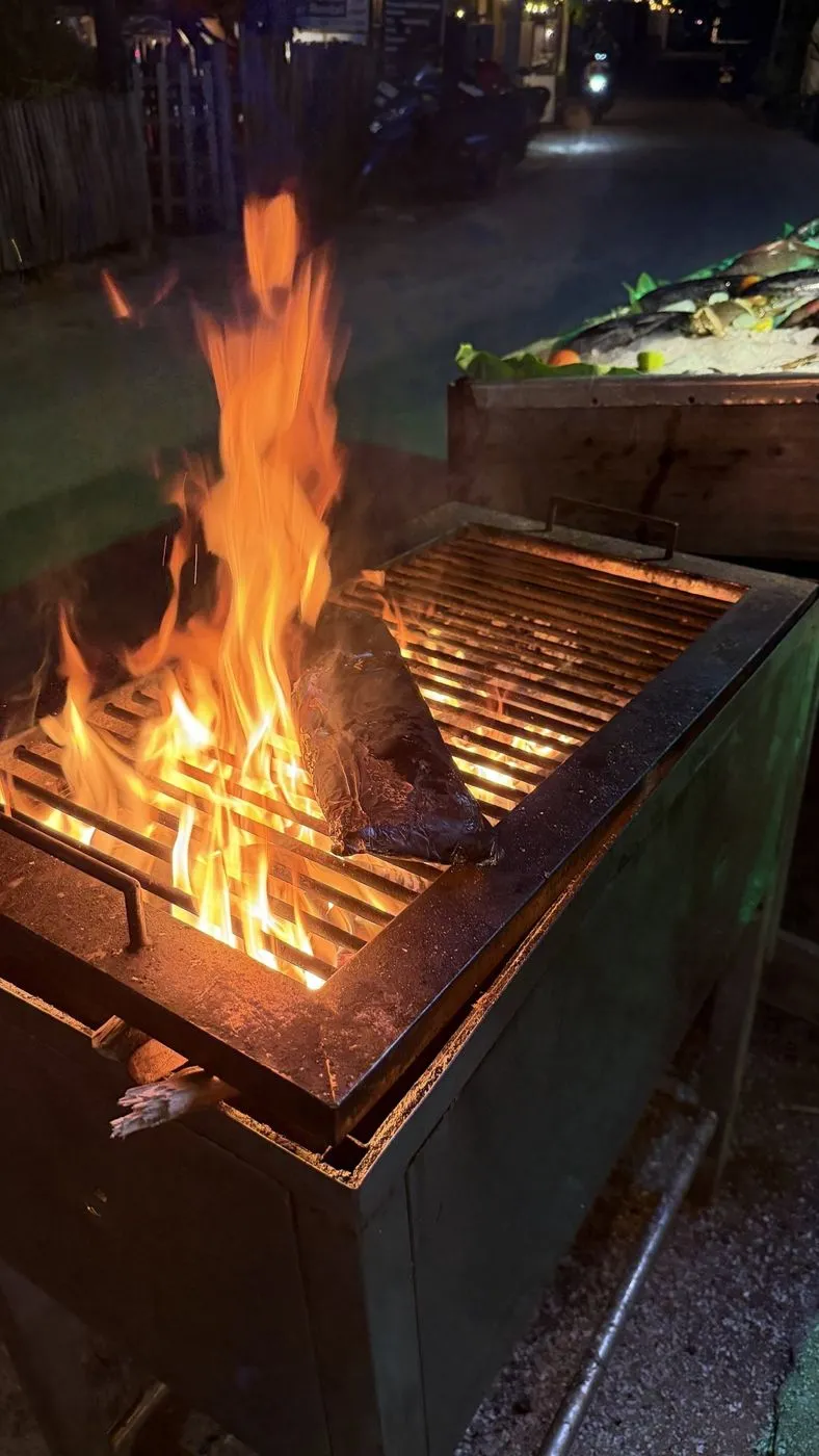 Our fish going on the open-flame grill