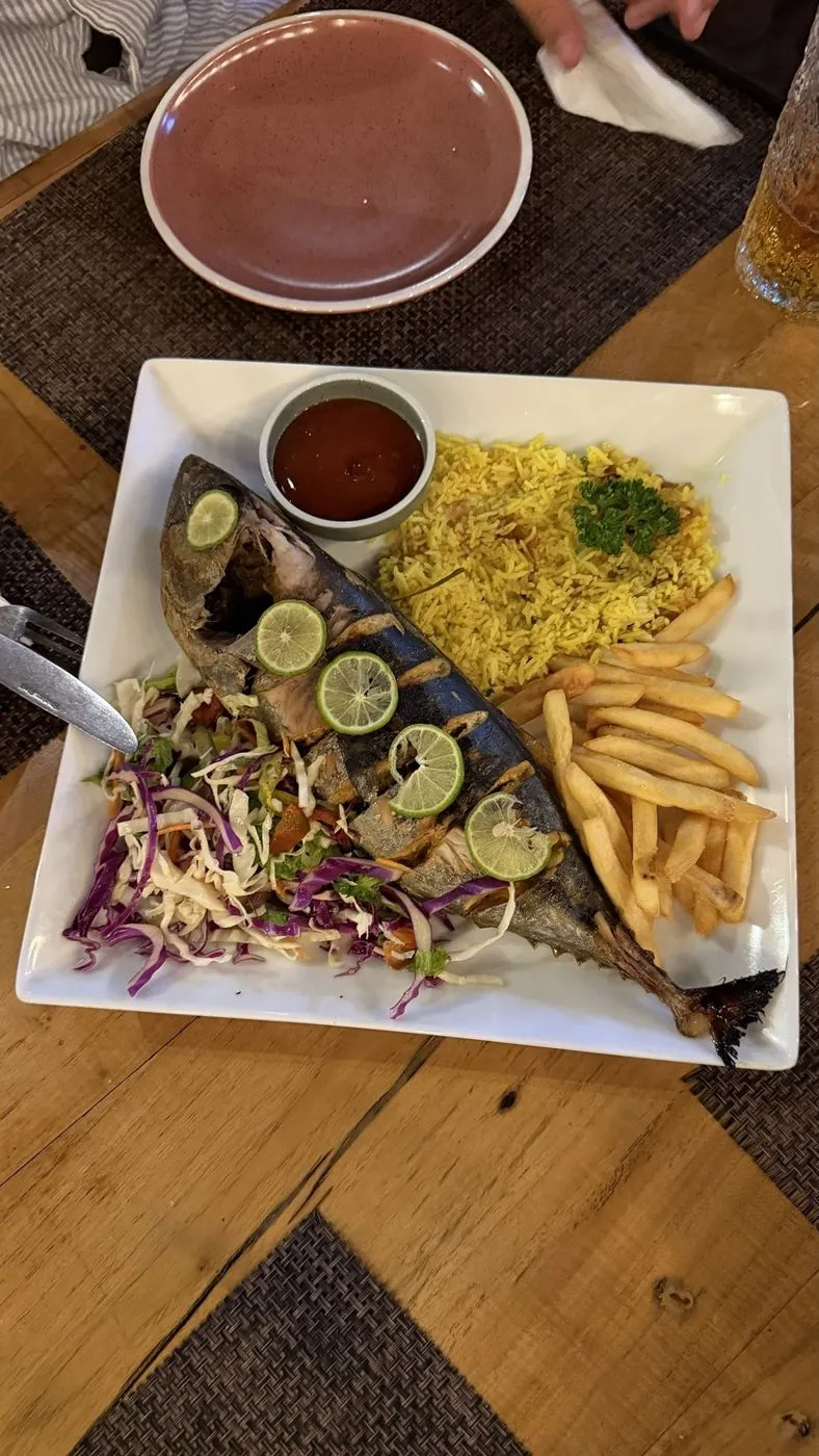 Whole grilled fish with lime, yellow rice, fries and slaw