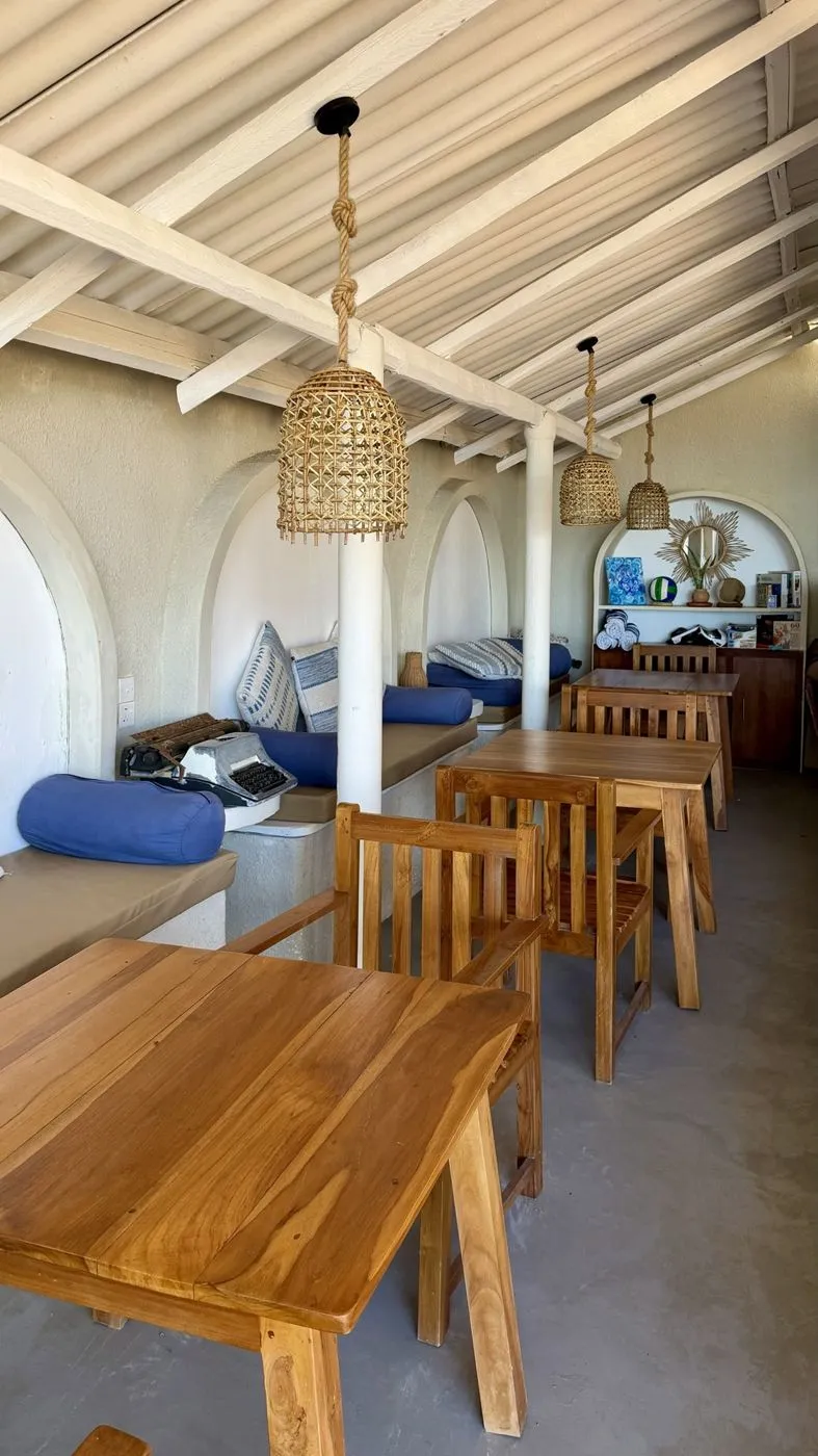Arched lounge nooks with blue cushions and an old typewriter