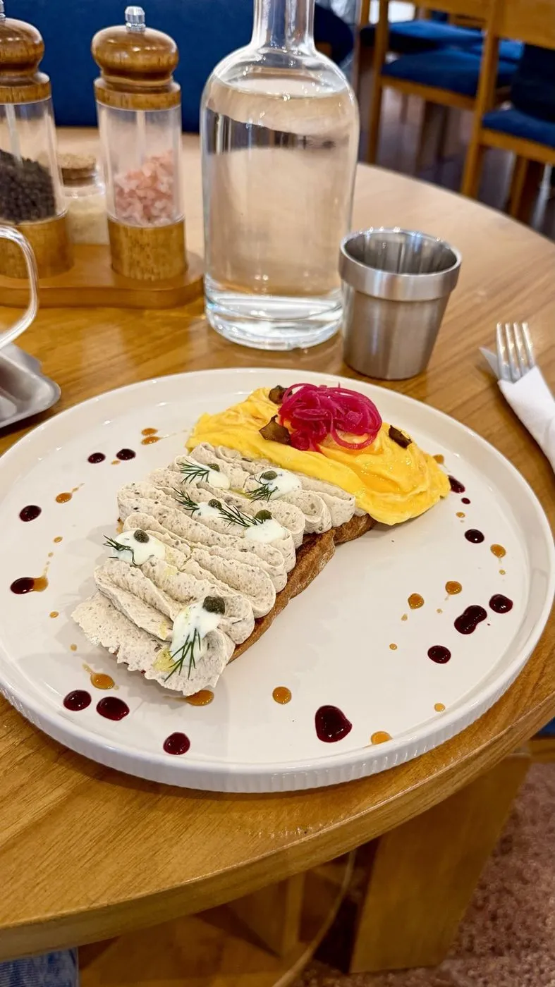 Sourdough with whipped spread, soft scrambled eggs and pickled onion
