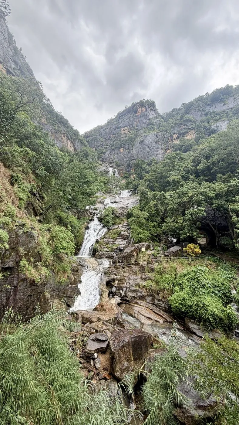 The falls under grey skies, cliffs rising on both sides