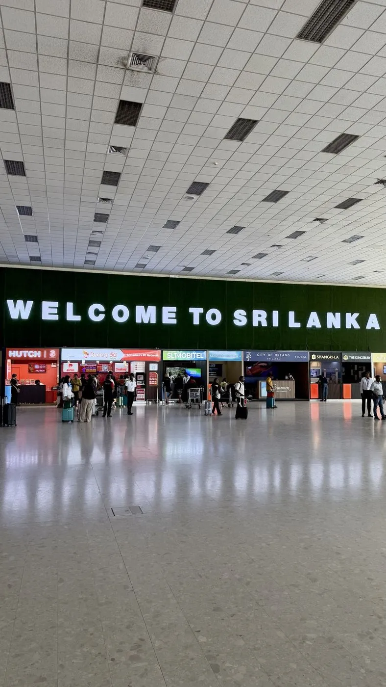 Arrivals hall at Bandaranaike airport, with the SIM counters (Dialog, Hutch, SLT-Mobitel) under the big welcome sign