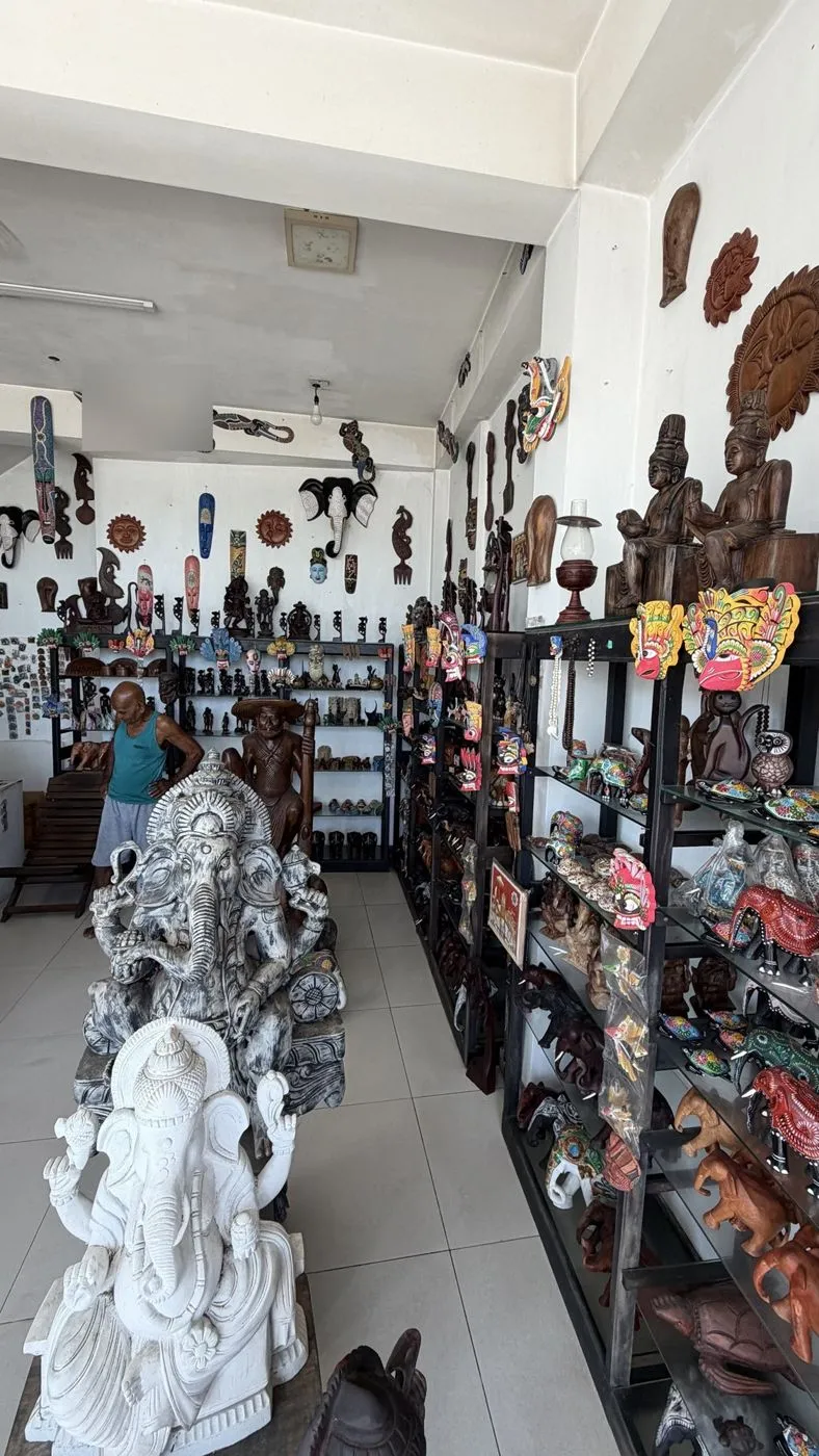 Inside the wholesale woodcraft shop: carved Ganeshas, masks and painted elephants